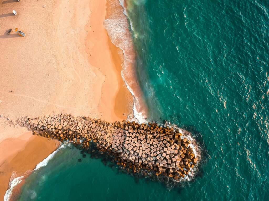 Drone shot capturing Luanda's stunning coastline with golden sands and azure waters.