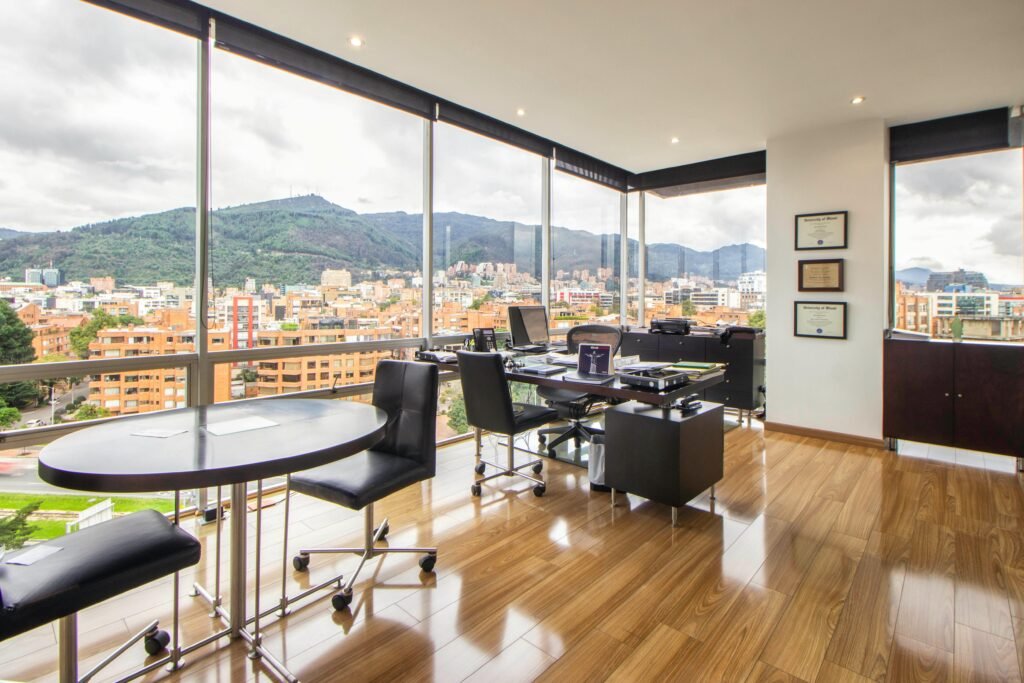 pexels photo 7377687 7377687 Spacious modern office with a scenic city view through glass windows.