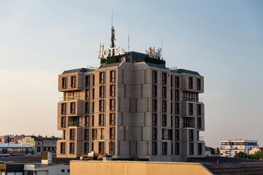 A modern hotel building in Pančevo, Serbia, captured during sunset with clear skies.