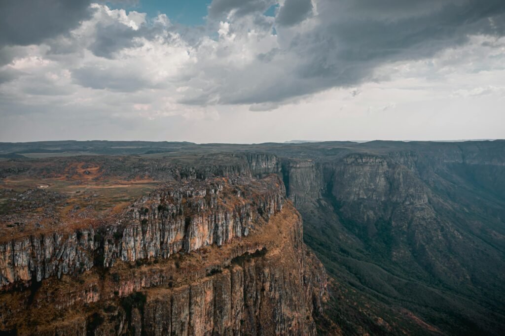 Breathtaking view of rugged canyons and cliffs under a vibrant sky in Huíla, Angola.